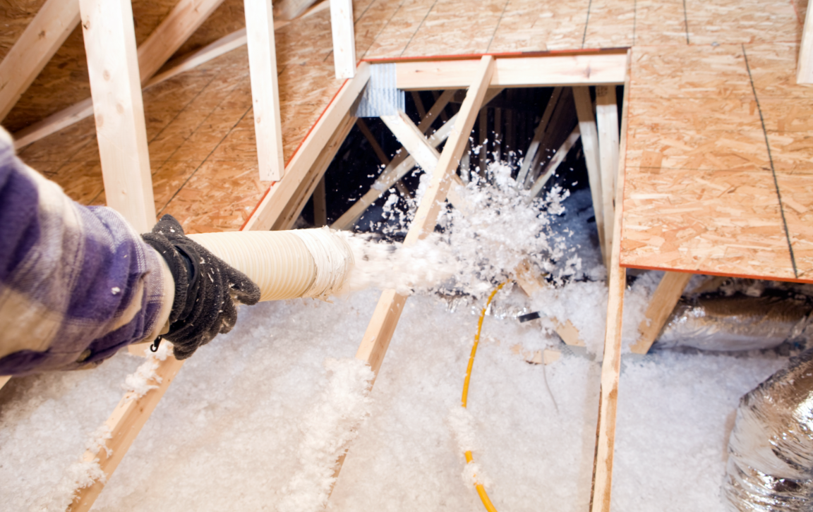 GettyImages-185126412@2x Contractor adding blown in insulation