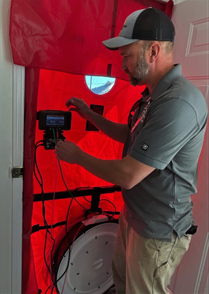 Nick Phillips using a blower door